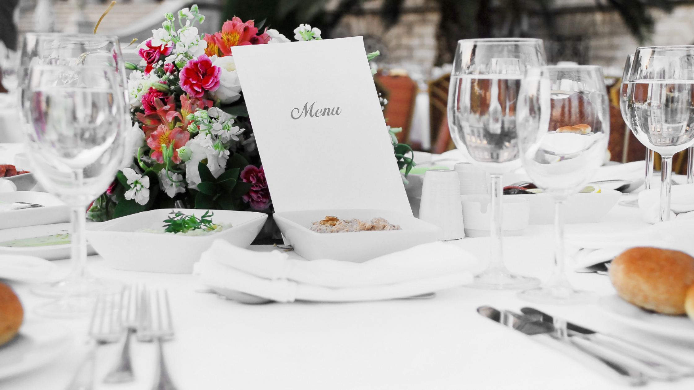 Event professionals discussing the sale of a catering and event venue, highlighting Meritus Group's expertise in facilitating successful transactions.