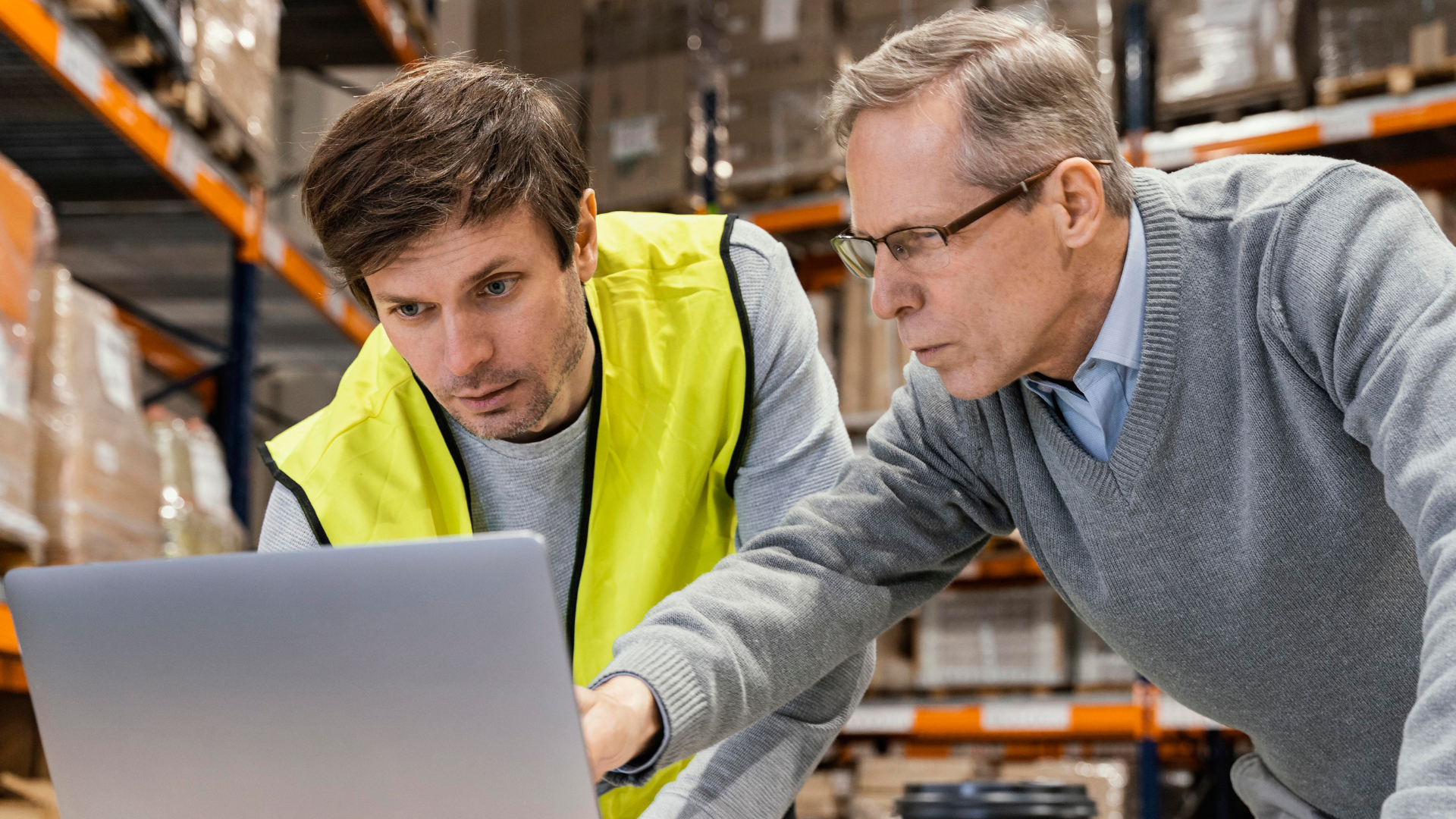 Manufacturing business owner shaking hands with a buyer, representing a successful sale and transition.